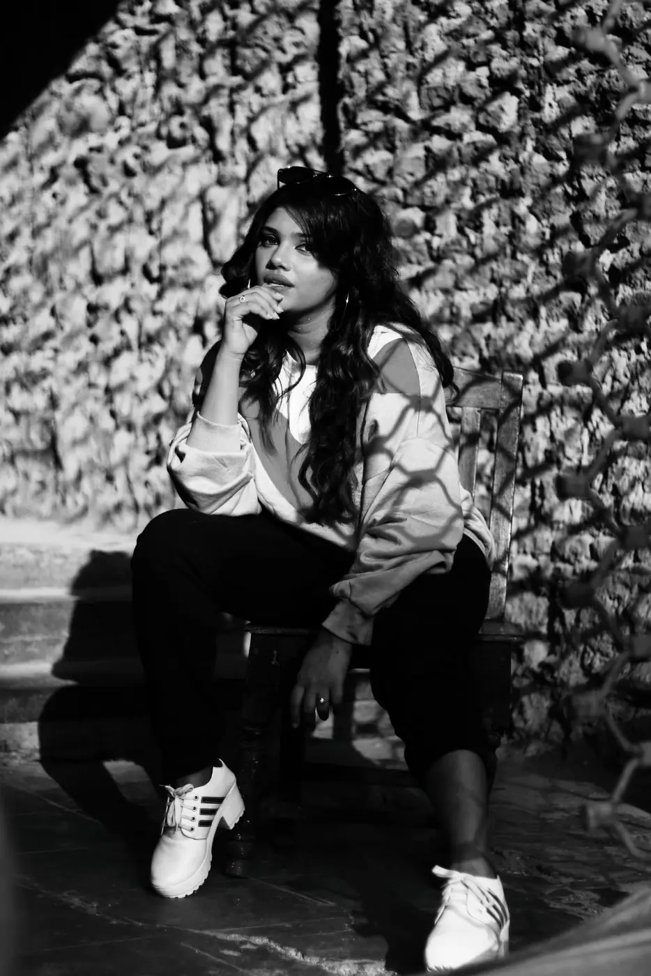 Obsidian example: woman in sweats sitting against a stone wall