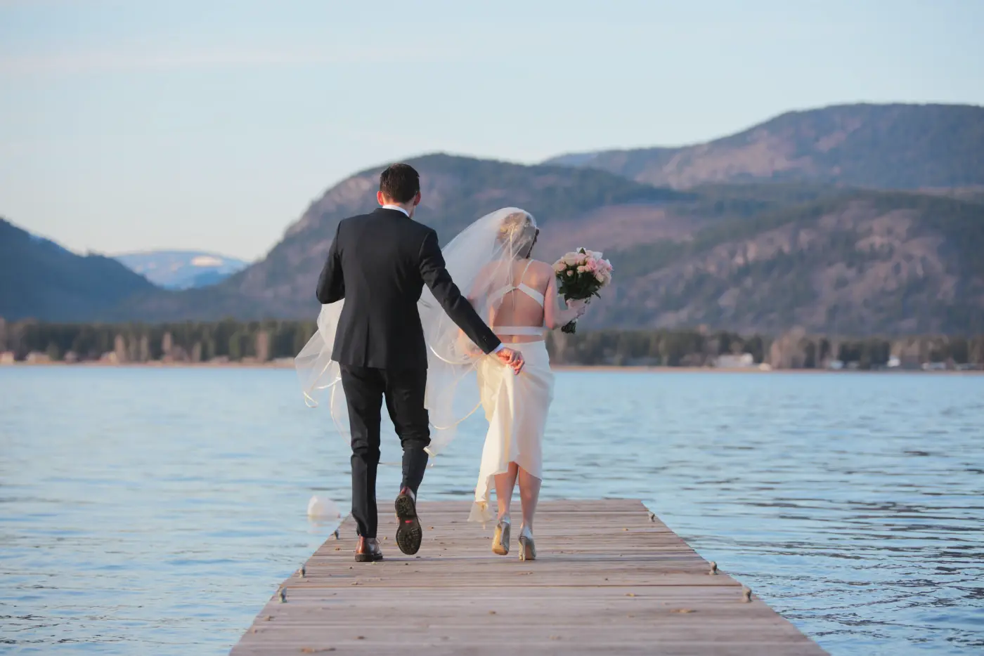 Pastel Dream example: bride and groom walking down a lake dock